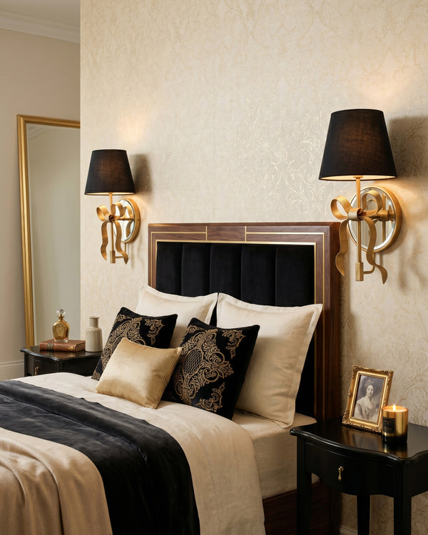 Colette Mirrored Bow Wall Sconce beside a bed