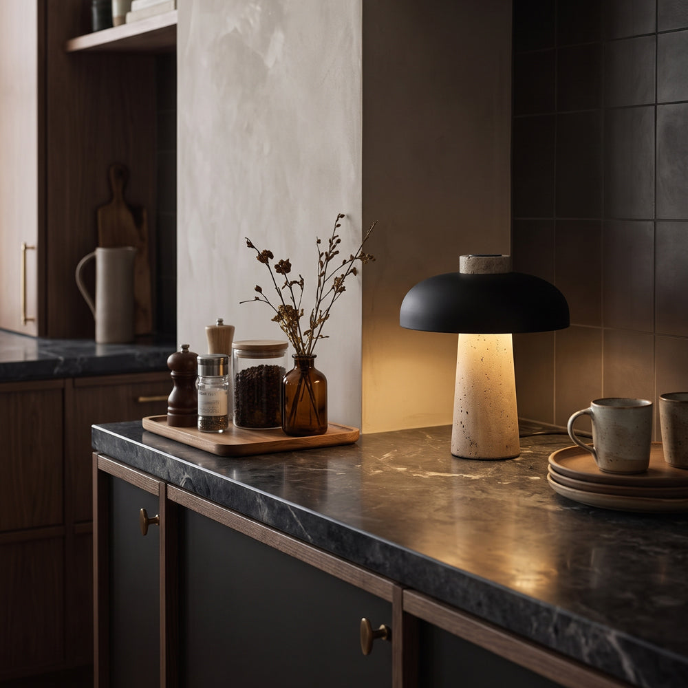 Reverse travertine lamp with black shade on a dark stone kitchen counter