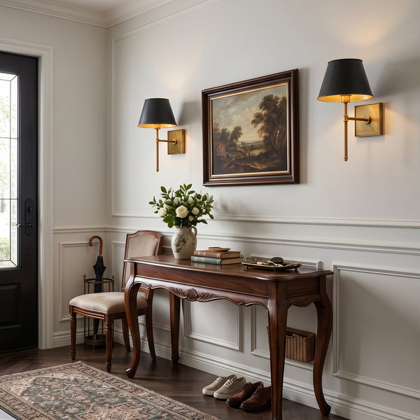 Two Rhodes wall sconces on either side of a landscape painting above an entryway console table